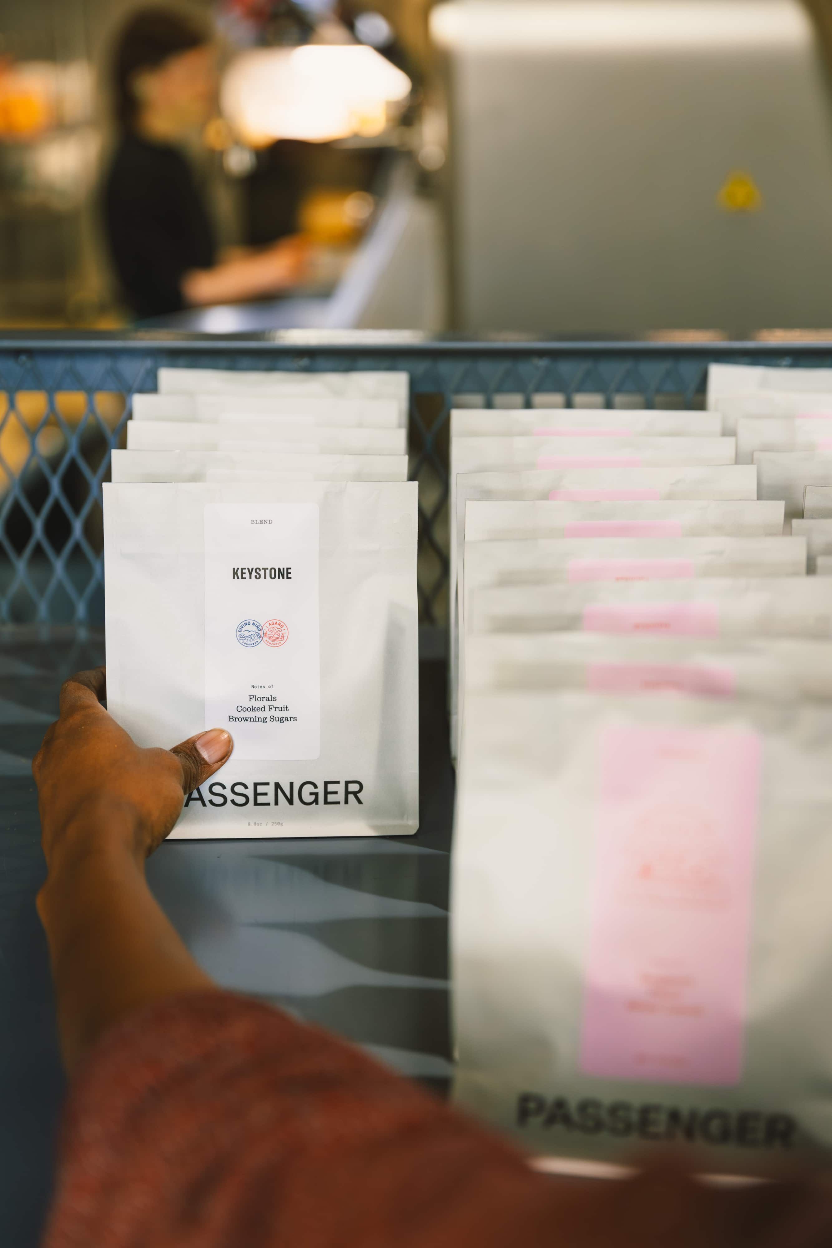 A production team member from Passenger organizes coffee ready for shipment