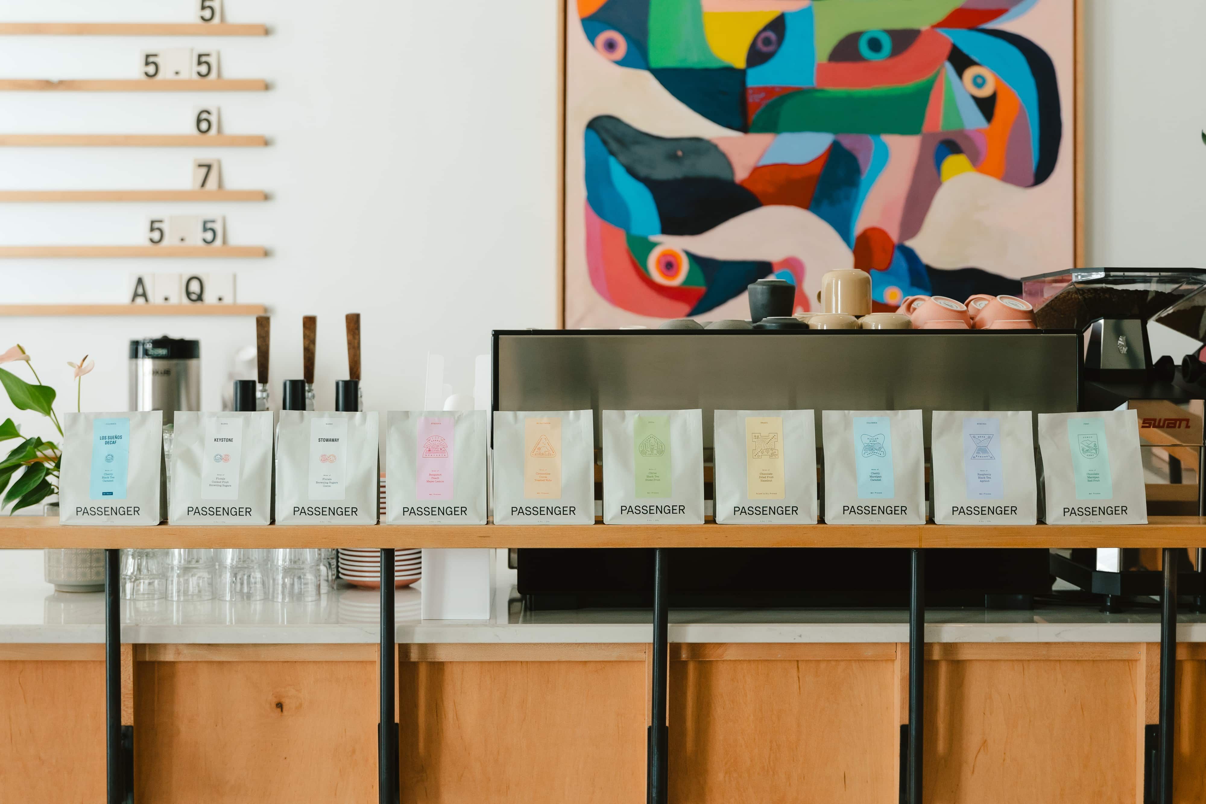 A shelf with all of Passenger's foundational coffee's lined up on it