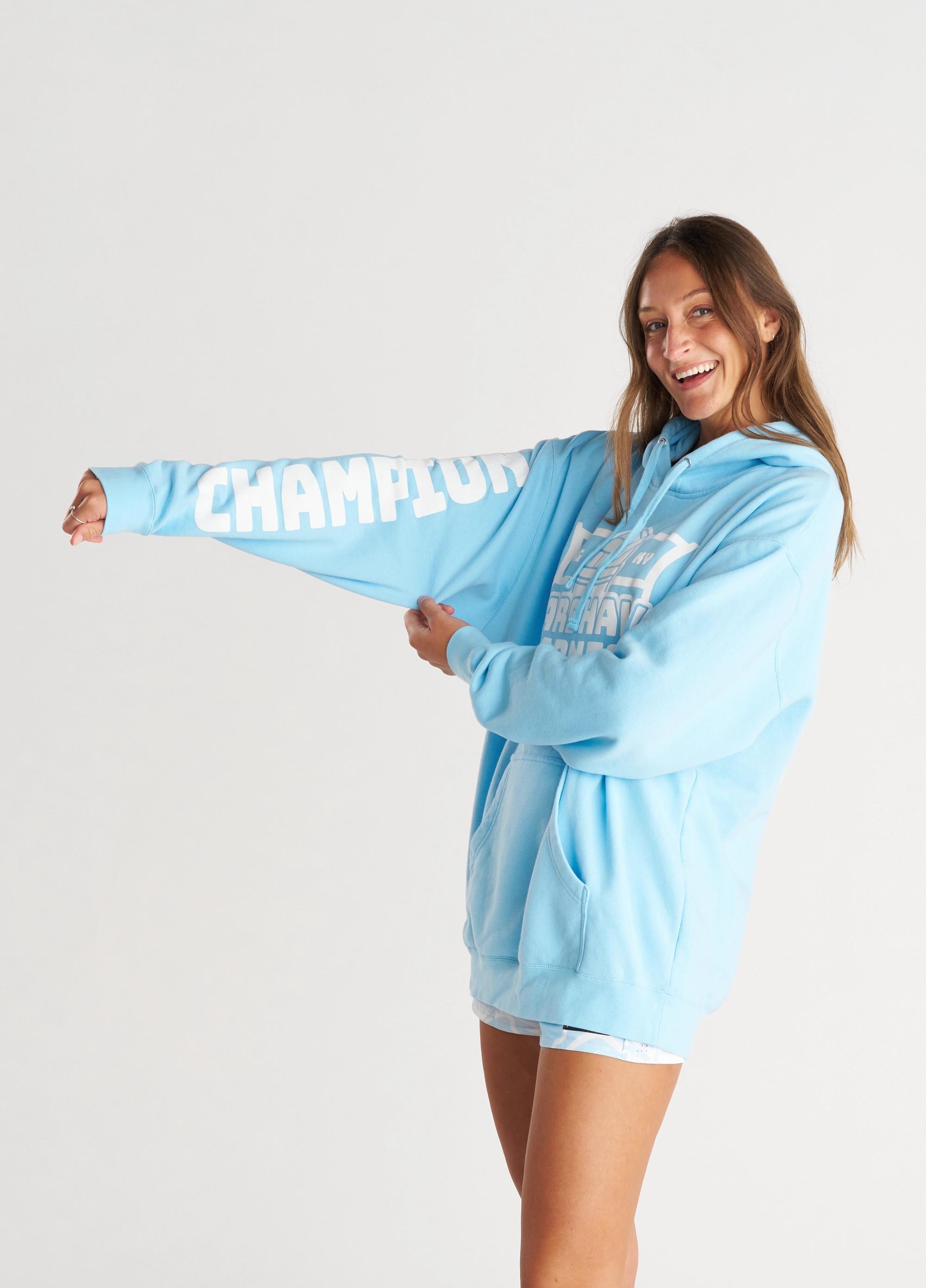 Girl wearing light blue hoodie with white graphics & text