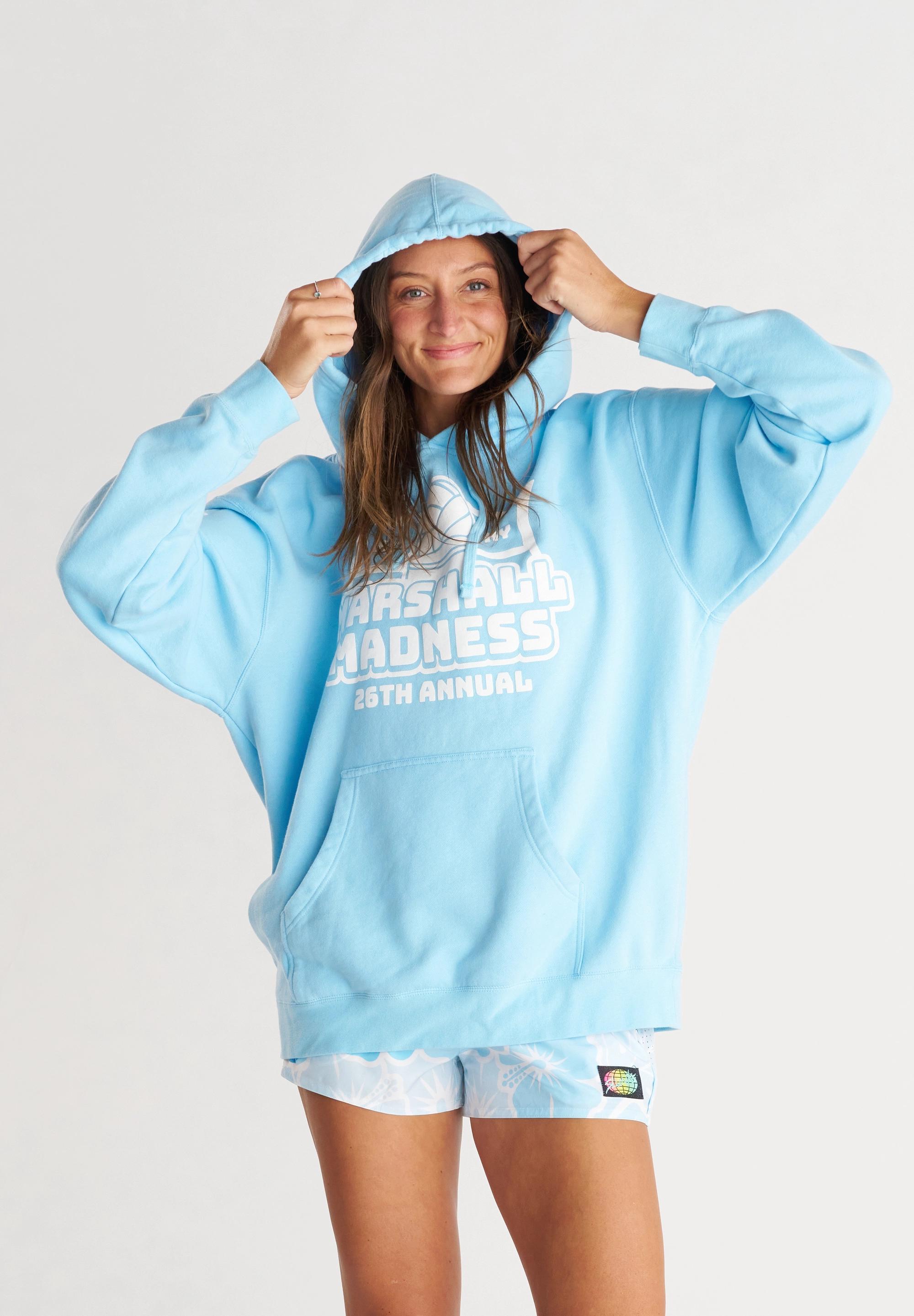 Girl wearing light blue hoodie with white graphics & text