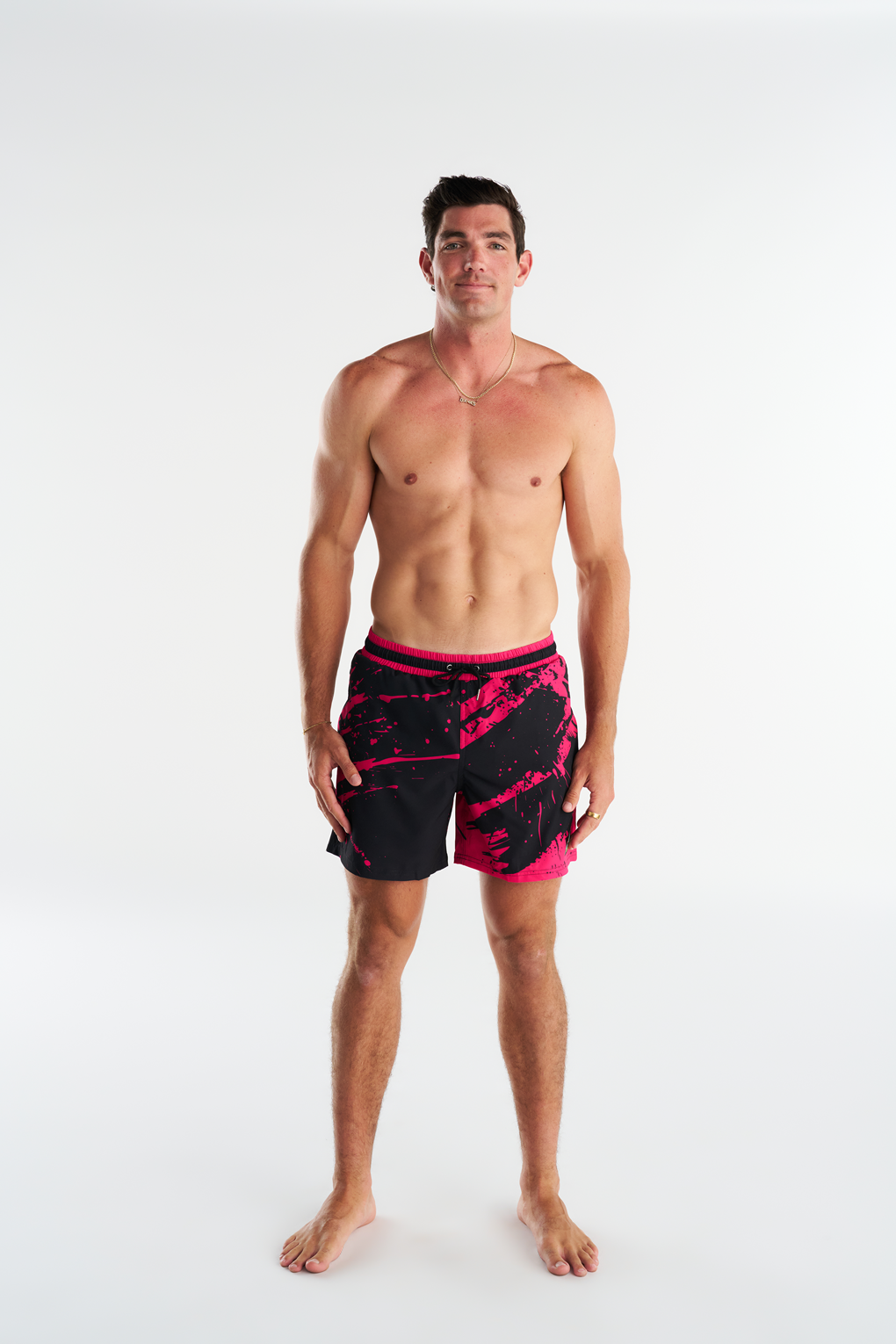 Troy Field wearing his custom Slunks boardshorts, black shorts with pink abstract graphics