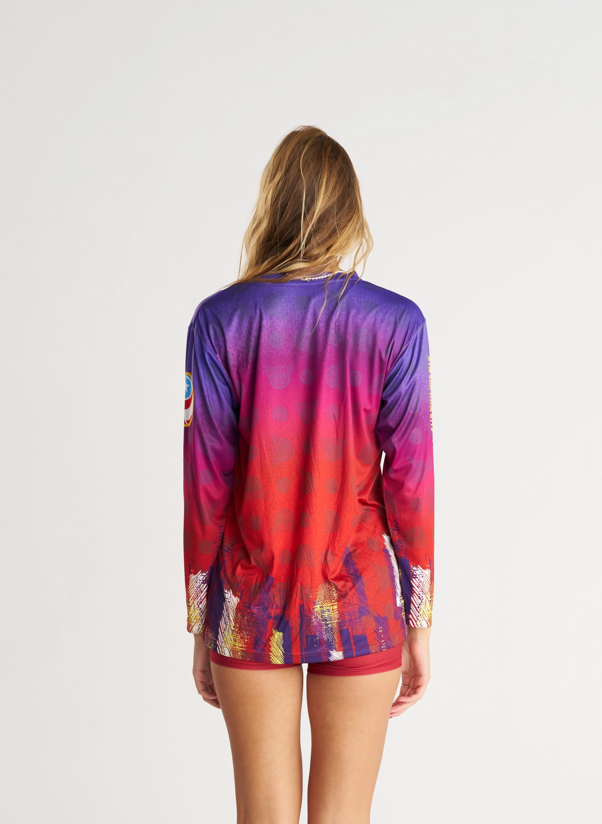 long sleeve warm up jersey on woman wearing matching spandex. purple and red gradient graphic