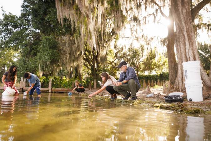 Rollins students completing research on Lake Virginia alongside chemistry professor Pedro Bernal