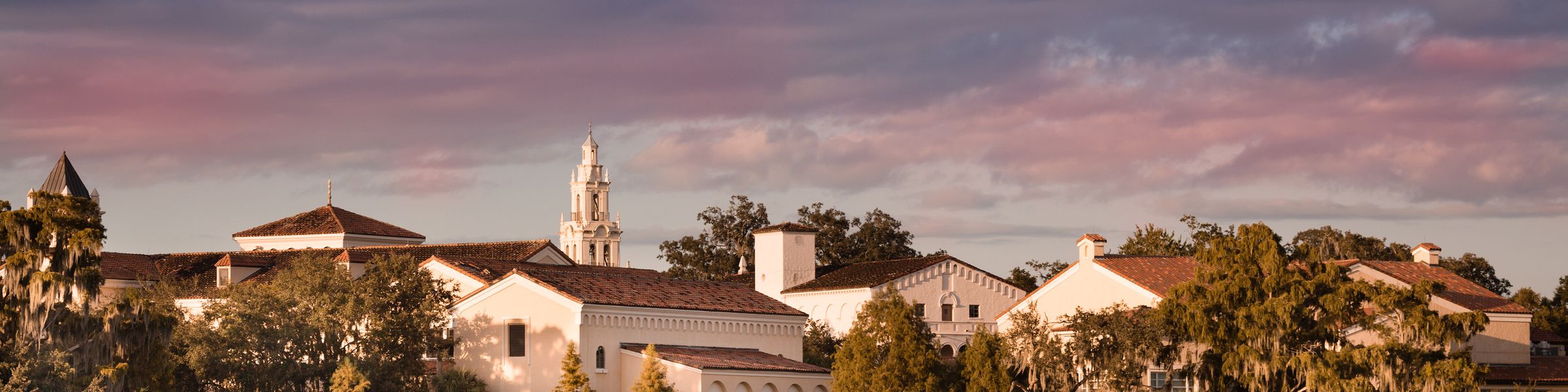 A lake view of the Rollins College campus at dusk.