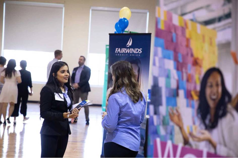 Students speak to recruiters at a career fair.