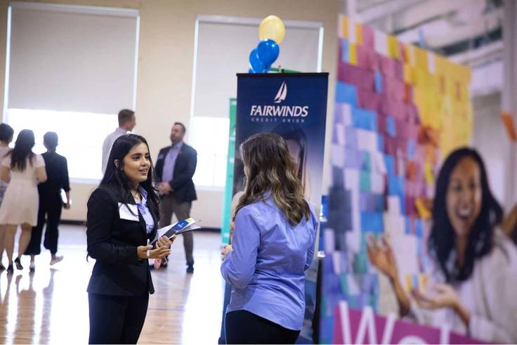 Students speak to recruiters at a career fair.