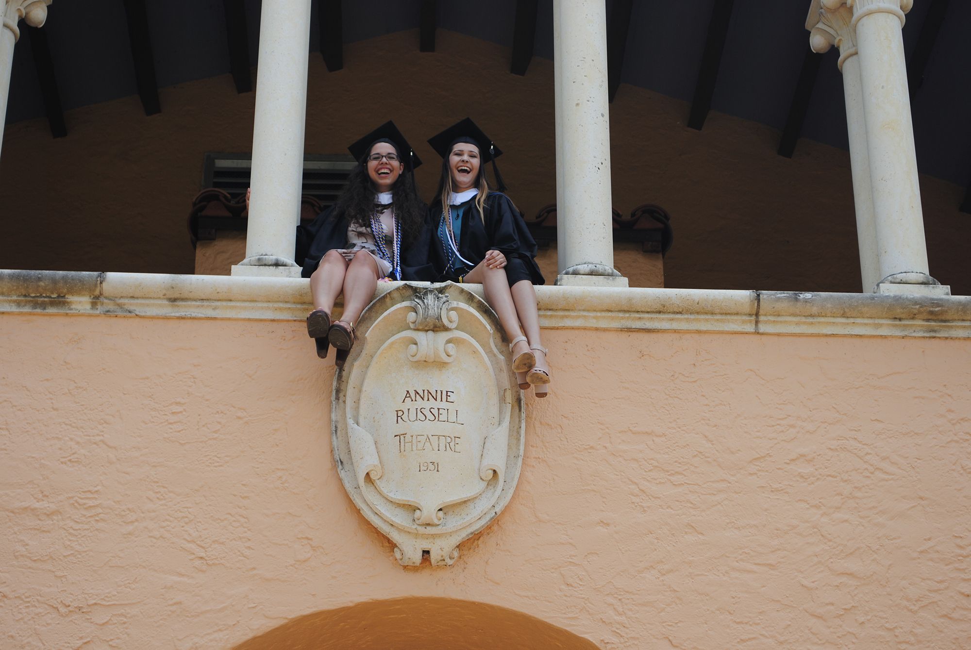 Kathleen Capdesuner and a friend above the entrance to Annie Russell Theatre.