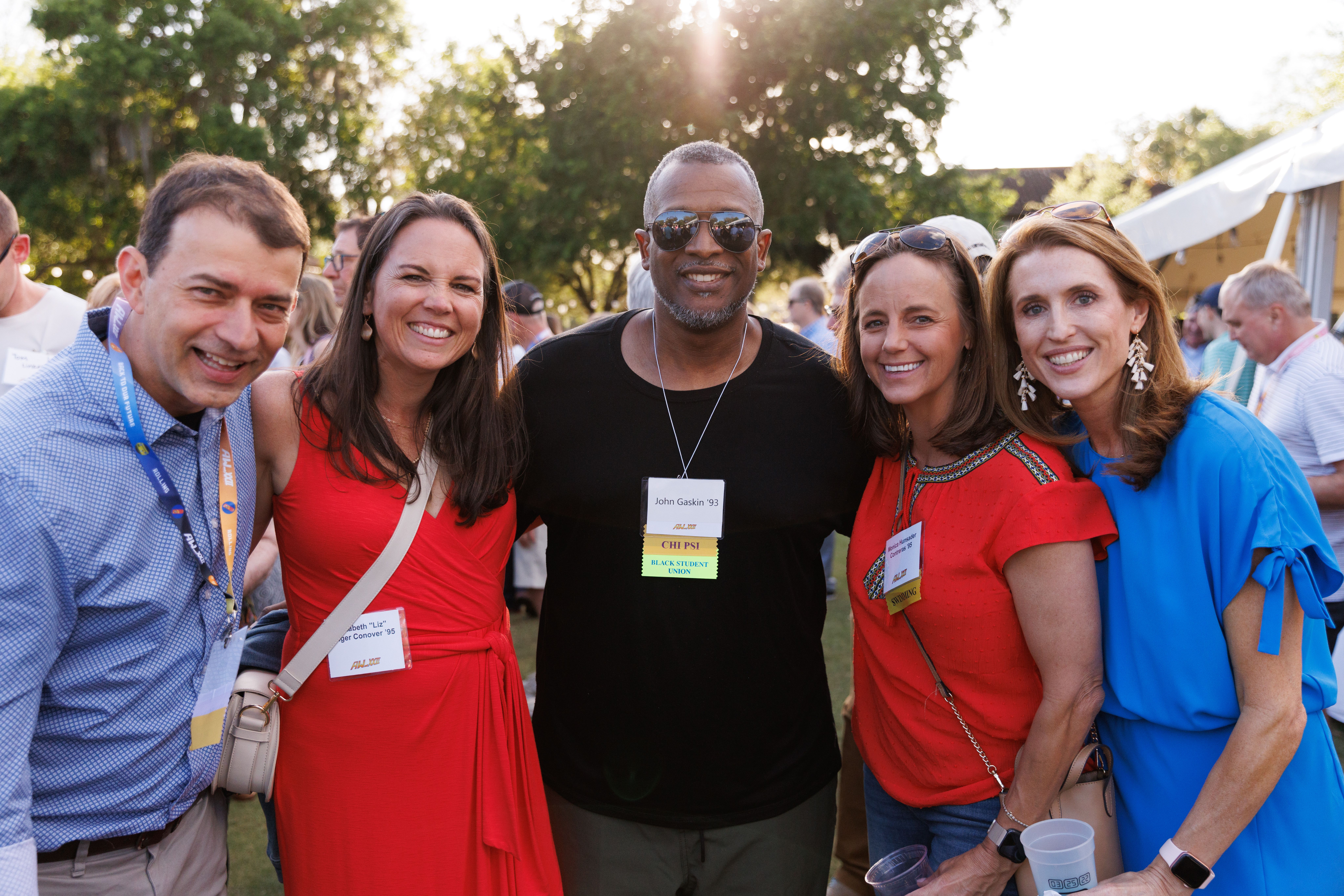 Five Rollins alumni gathered together during Alumni Weekend for a group photo.