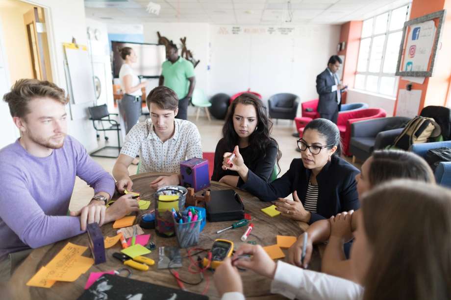 A group of social entrepreneurship students work on BatterEASE, an upcycled alternative power source.