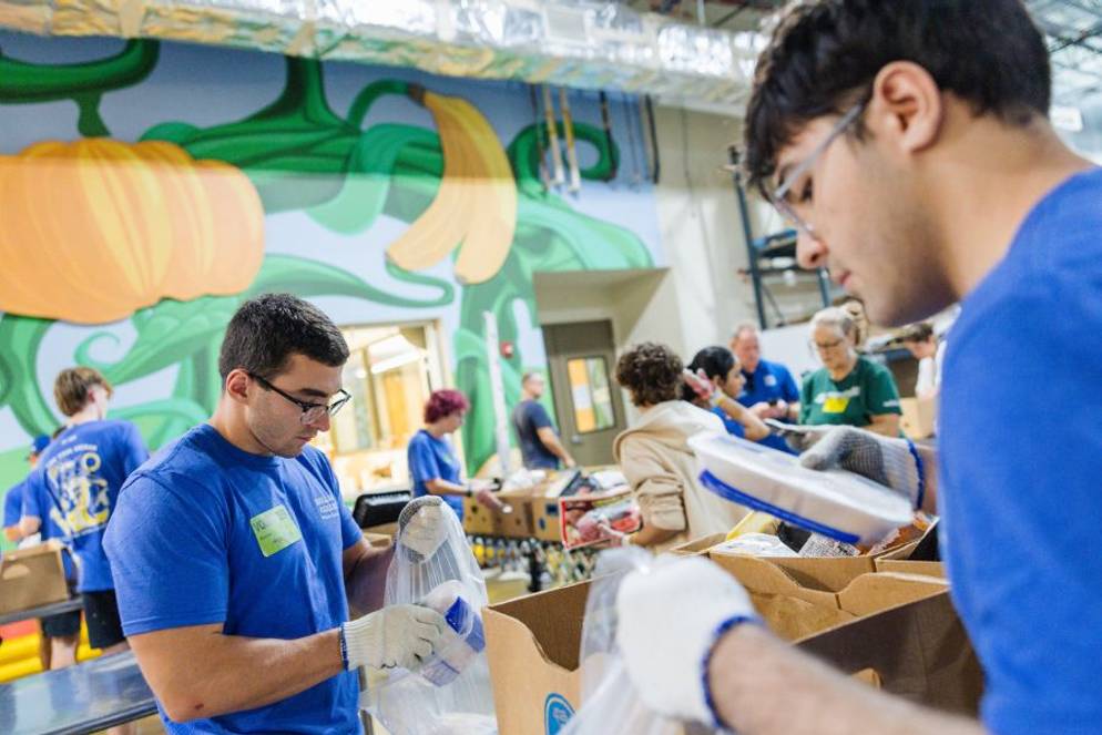 Rollins students packing food on a service project for Second Harvest Food Bank.