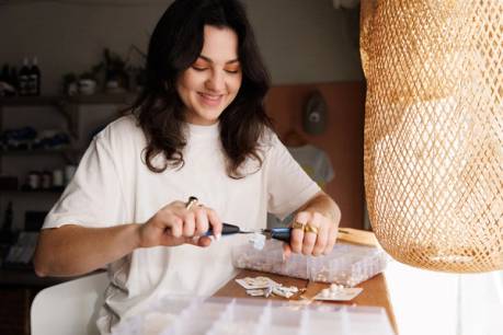 A student entrepreneur makes jewelry by hand 