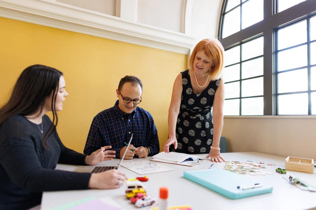 A professor works with two graduate students to perfect behavior analysis techniques.