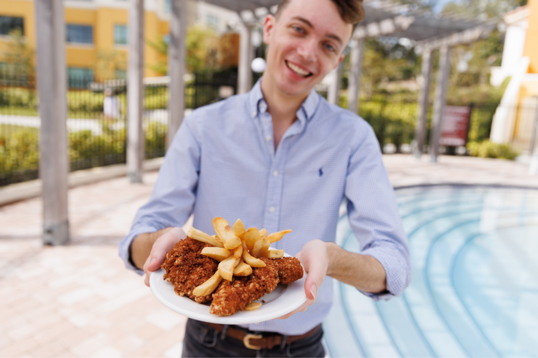 Rollins student Brendan Manning '23 with a plate of chicken tenders