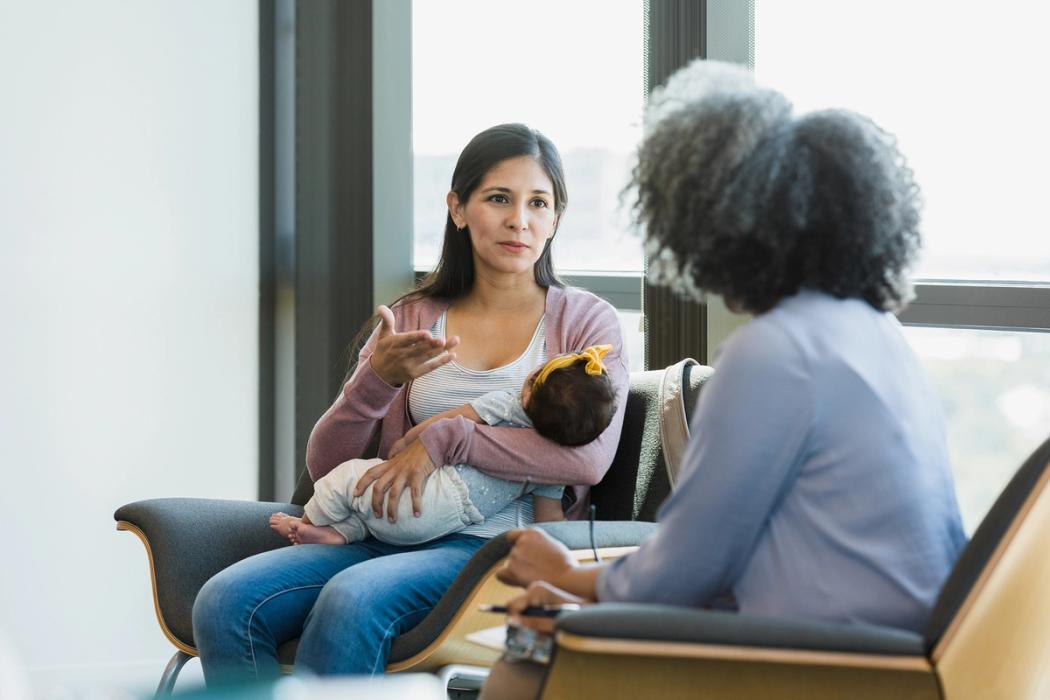 A maternal health specialist meets with a new mother.