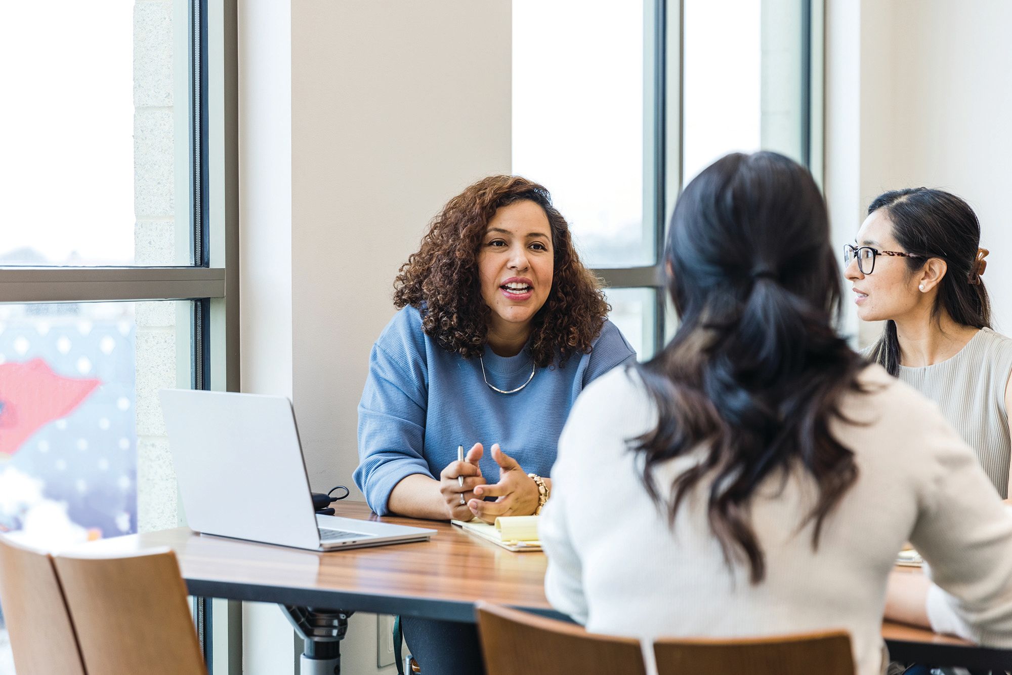 A group of graduate counseling students chats during a break from class.