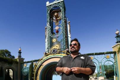 Charlie Stevens in front of Chronos Tower at Epic Universe.