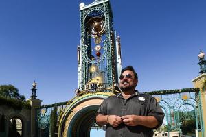 Charlie Stevens in front of Chronos Tower at Epic Universe.