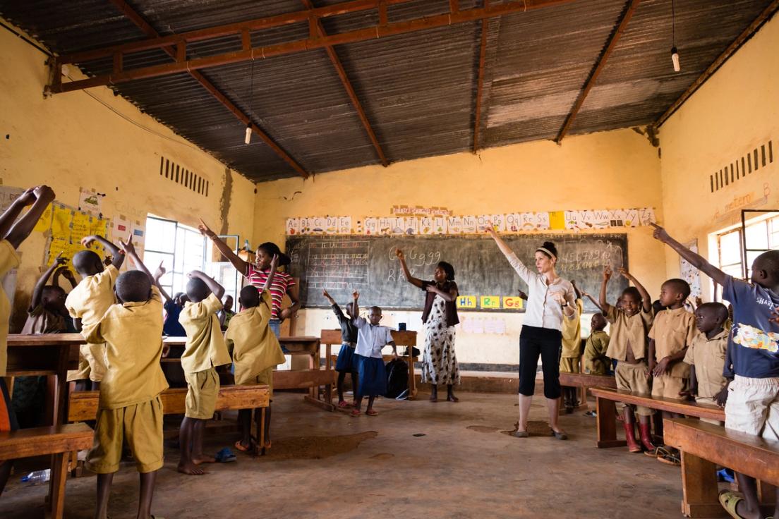 Holt elementary education graduate student Shakeela Prosper and Abby New ’06 ’13MED join with a P1 teacher in using physical activity to help teach English. The movements make it fun and strengthen language skills.