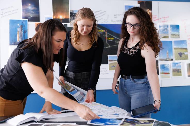 Physics professor Whitney Coyle (left) works with physics students Makayle Kellison ’25 and Maggie Kuffskie ’25 to analyze findings from their acoustical research on the launch of the Artemis I rocket.