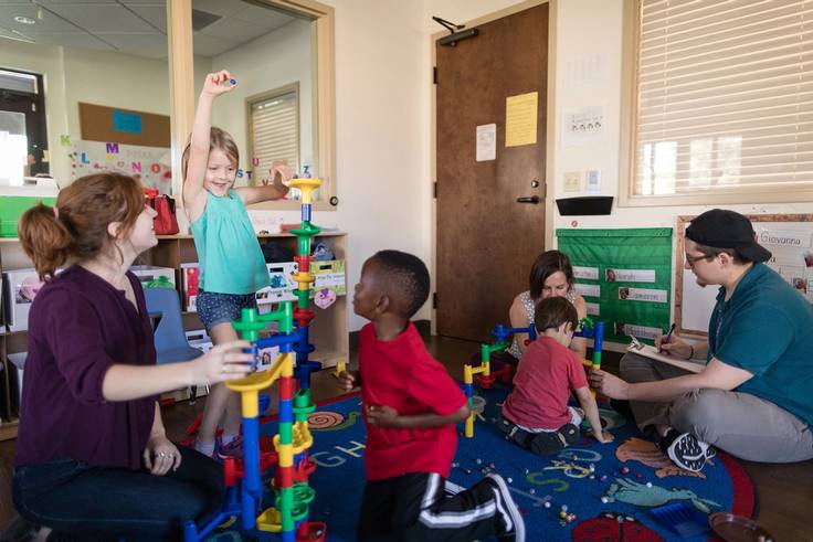 children and Rollins students play in the Child Development & Student Research Center