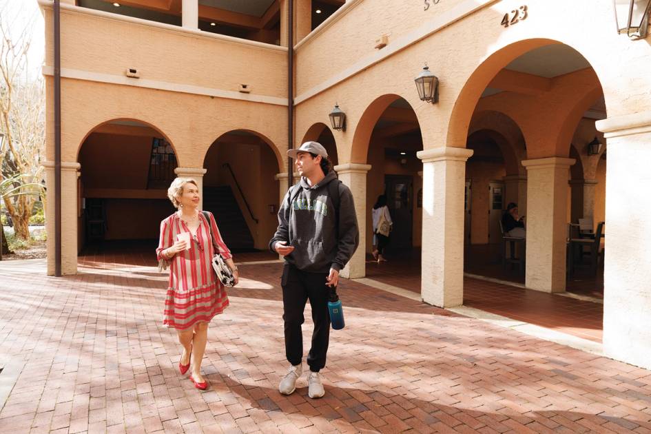 A Rollins College student and professor on campus.