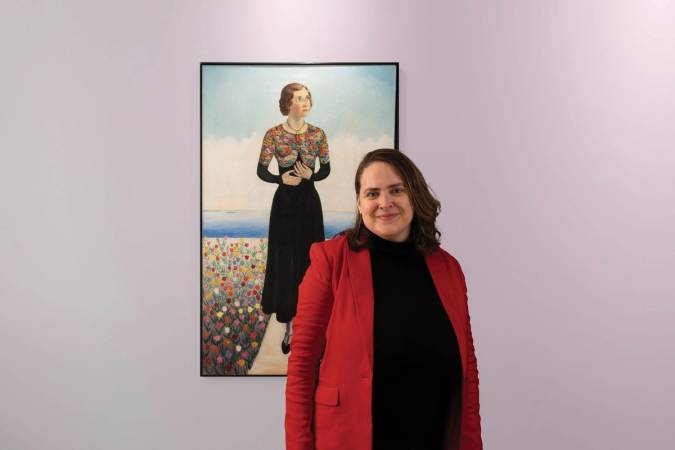 Leslie Anderson pictured in front of a piece of artwork at the Rollins Museum of Art