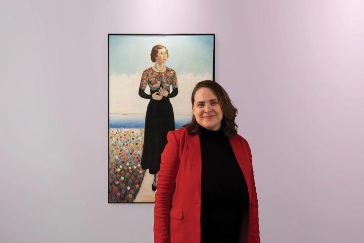 Leslie Anderson in front of a painting at the Rollins Museum of Art