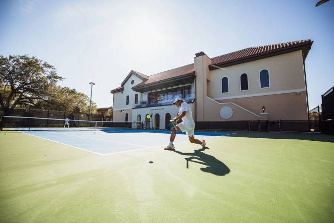 Student-athlete playing on the new tennis court