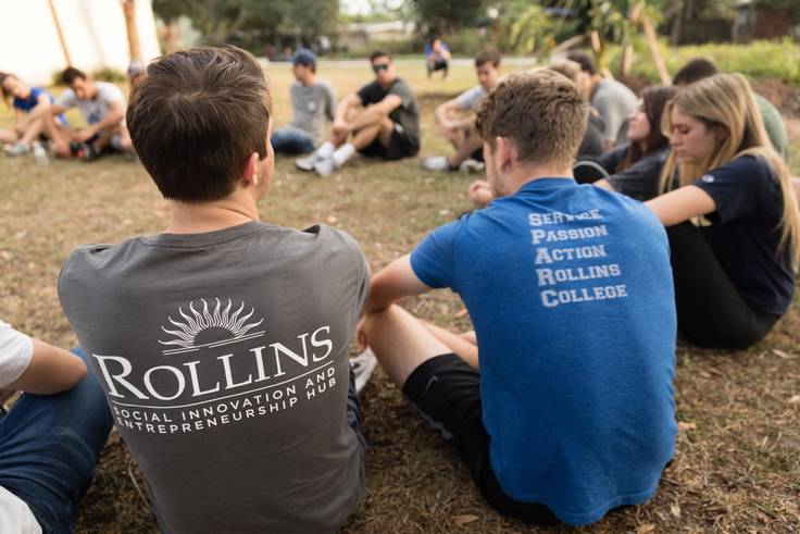 Students sporting SPARC day attire sit in a circle.