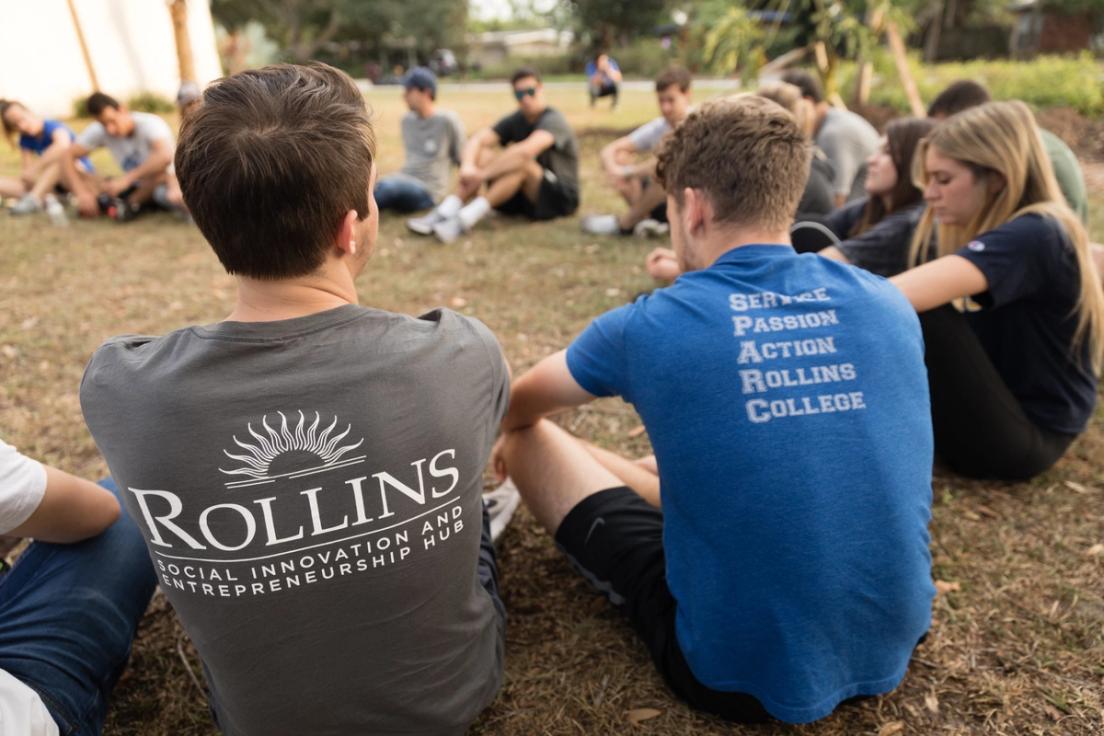 Students sporting SPARC day attire sit in a circle.