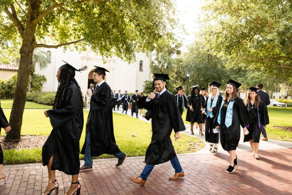 Students walk to the auditorium where commencement is being held.