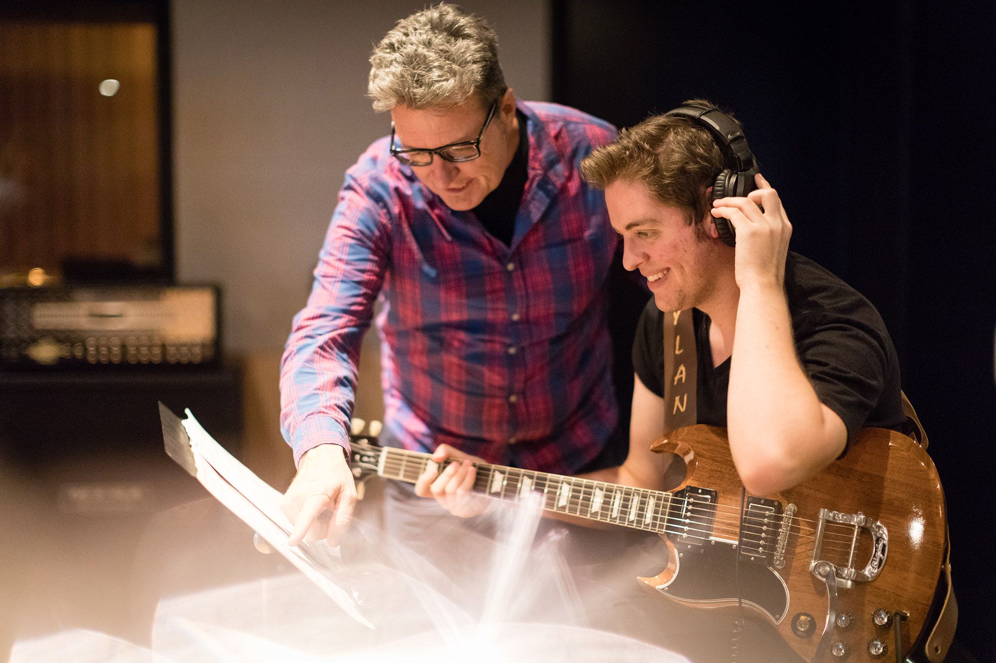 Music student gets tips on the guitar from a professor.