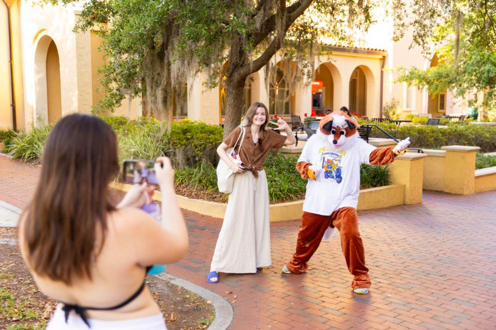 Student posing with the Fox mascot