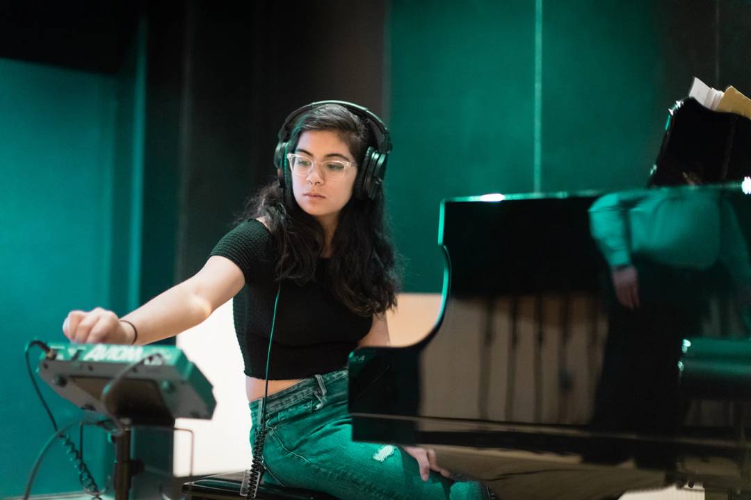 A Rollins music student practicing the piano.