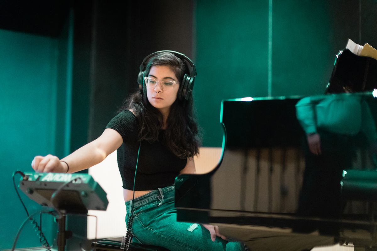 A Rollins music student practicing the piano.