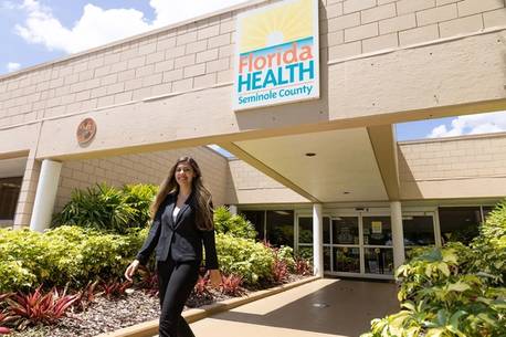 A student walks out of a Florida Health Department office.