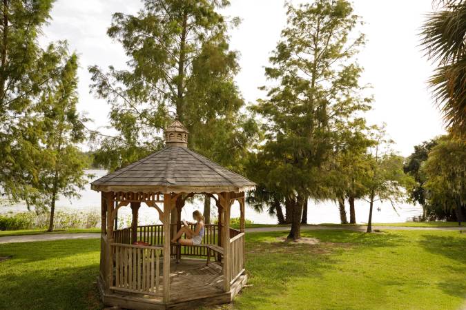 Student studying in a gazebo overlooking Lake Virginia.