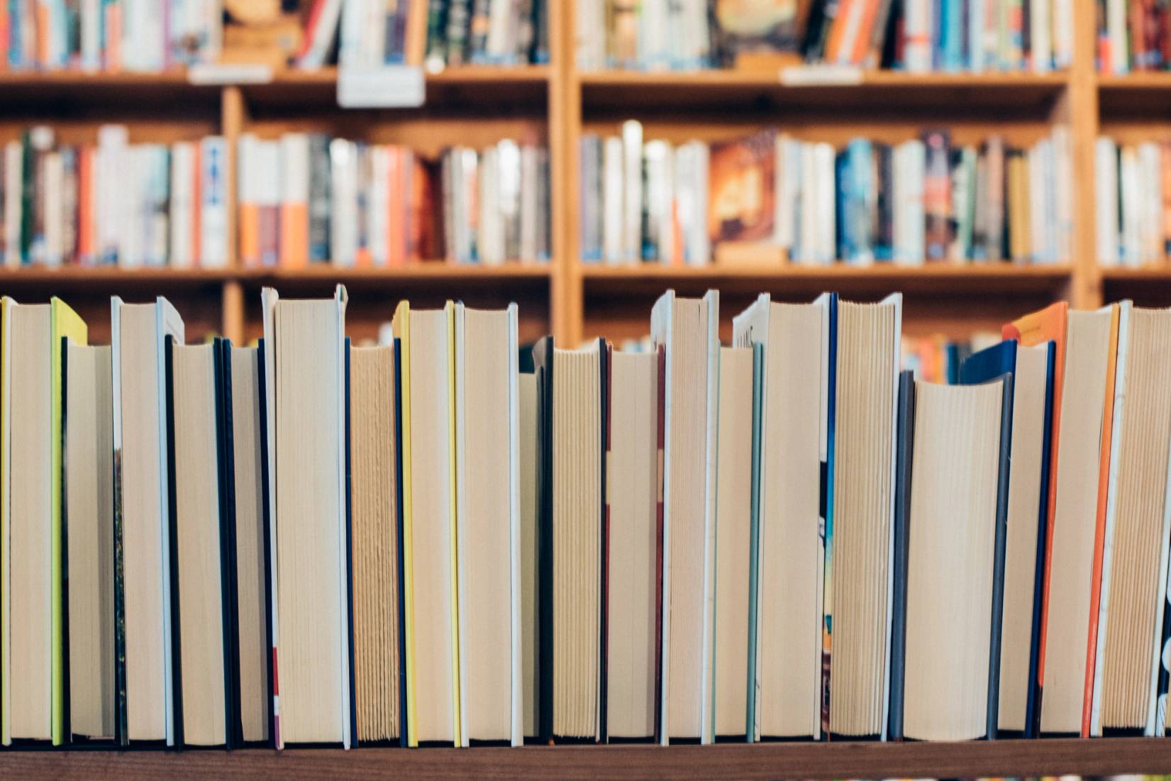 Rows of books stacked on shelves - bindings not visible.