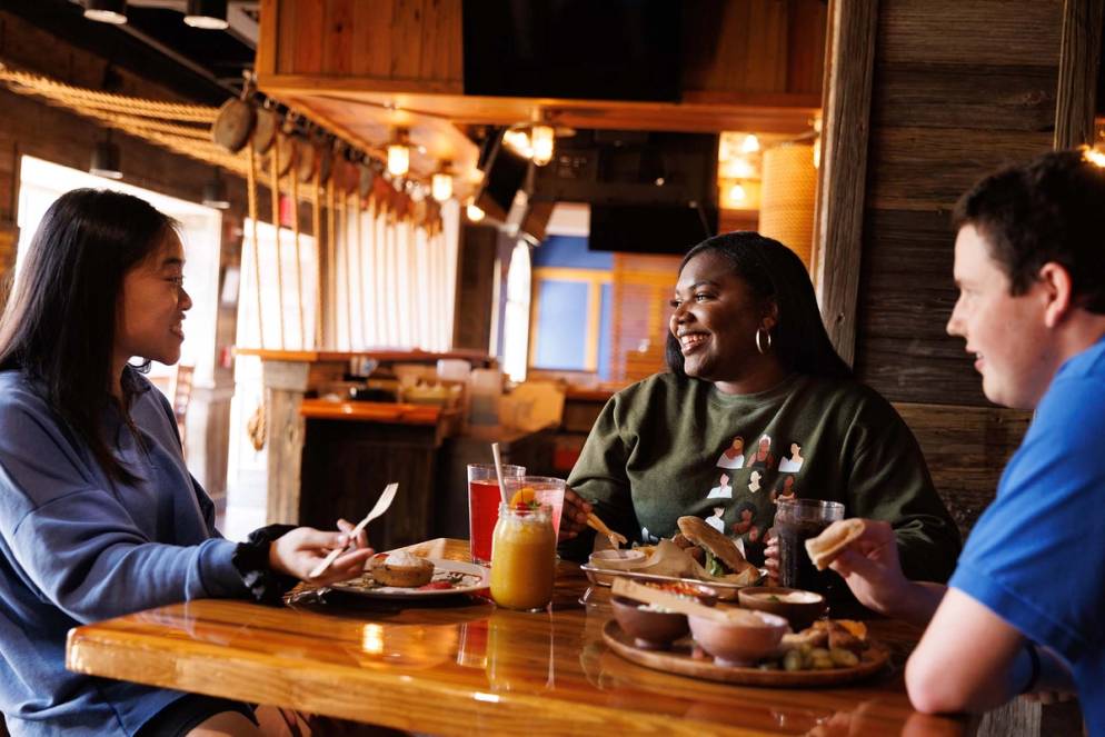 Students hang out in Dave's Boathouse while enjoying fresh fare.