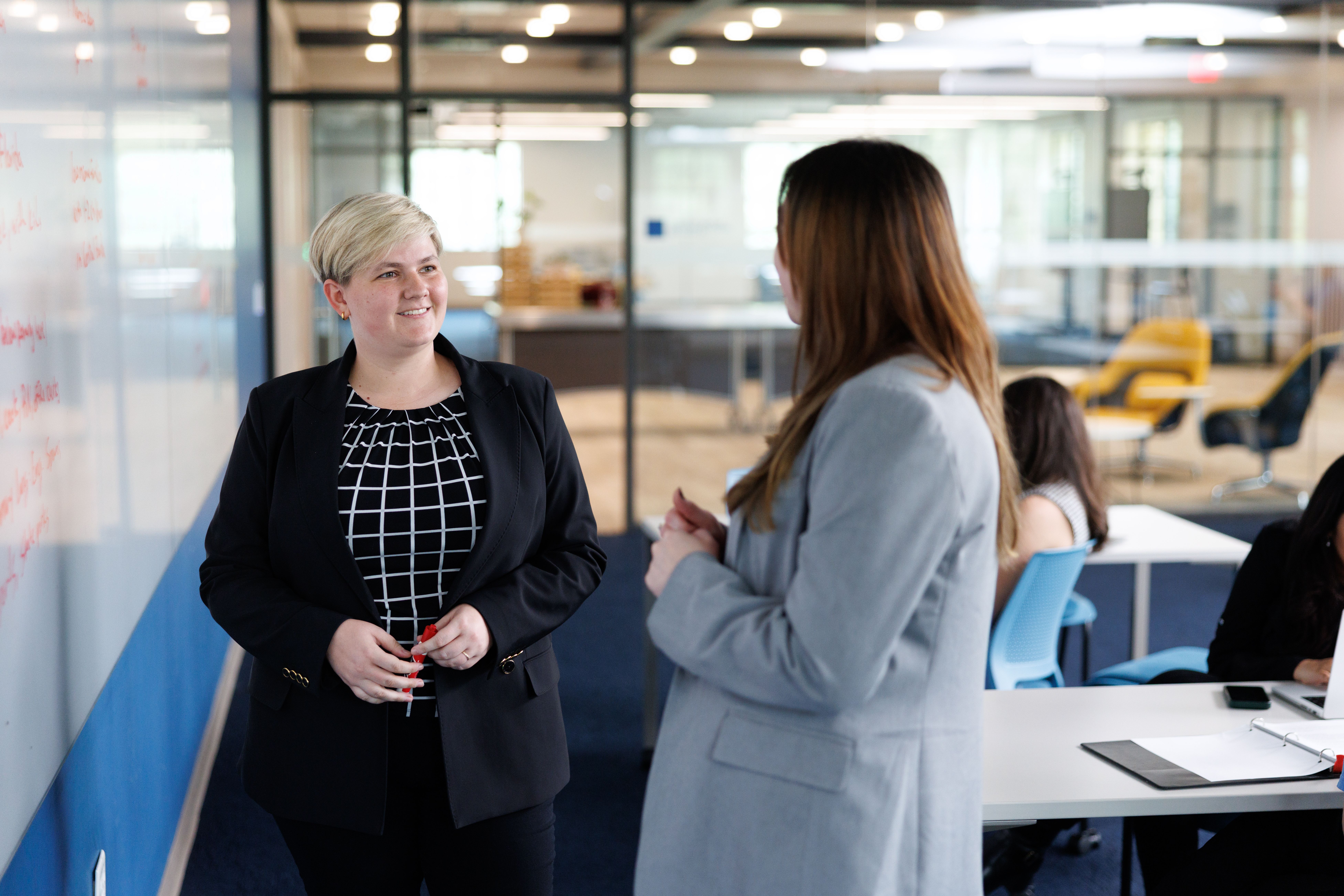 A communication professional reviews a new campaign with a colleague.