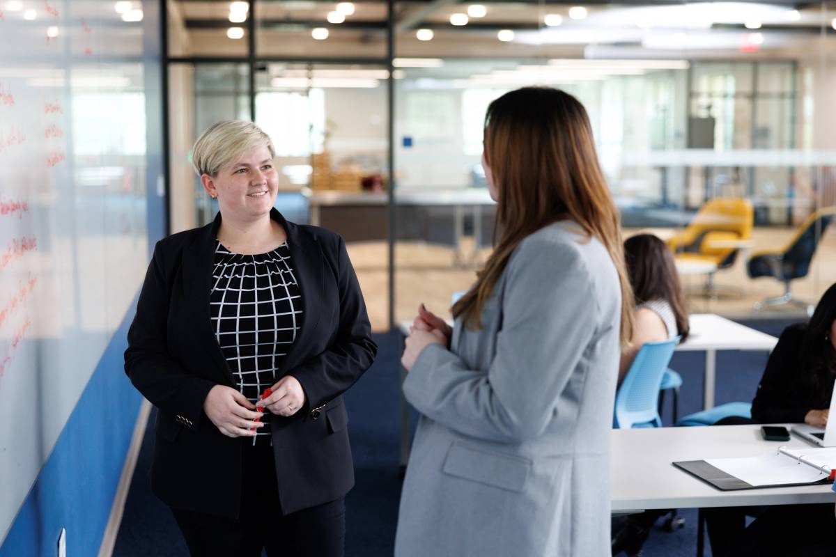 A communication professional reviews a new campaign with a colleague.