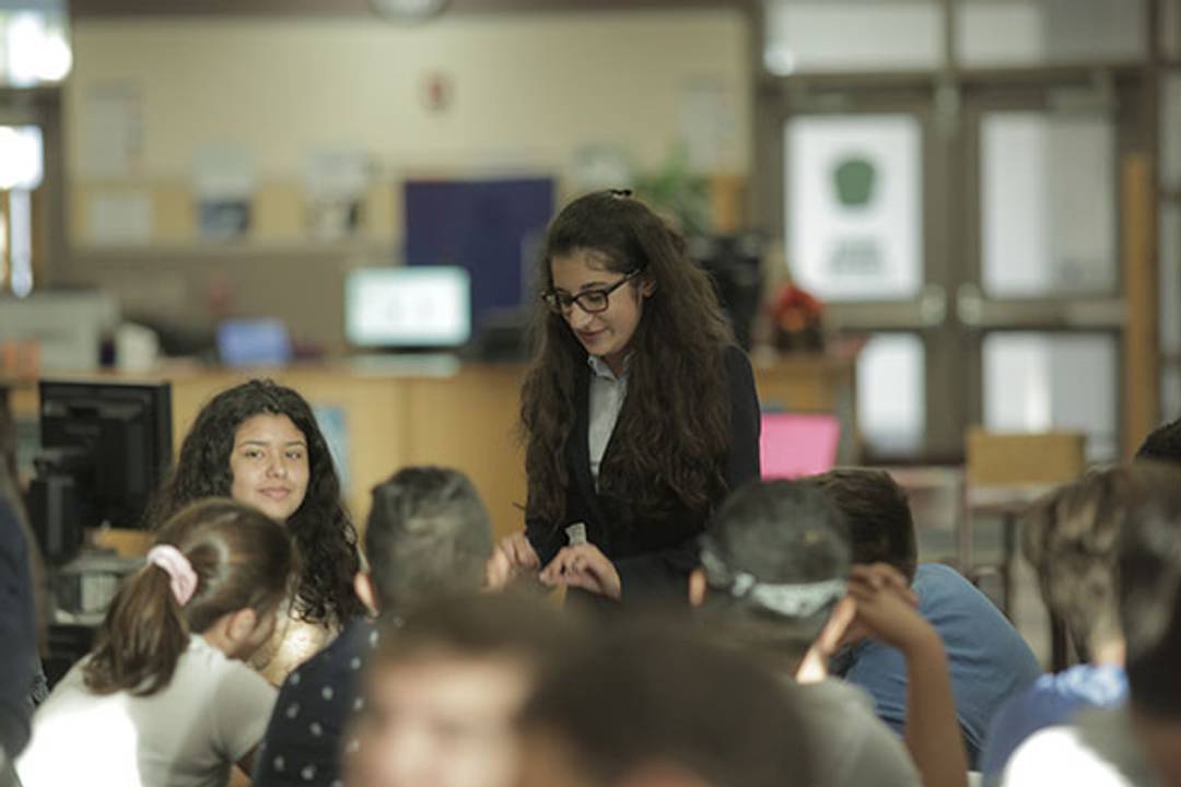 Rollins debate team member discusses college debating with students at Olympia High School.