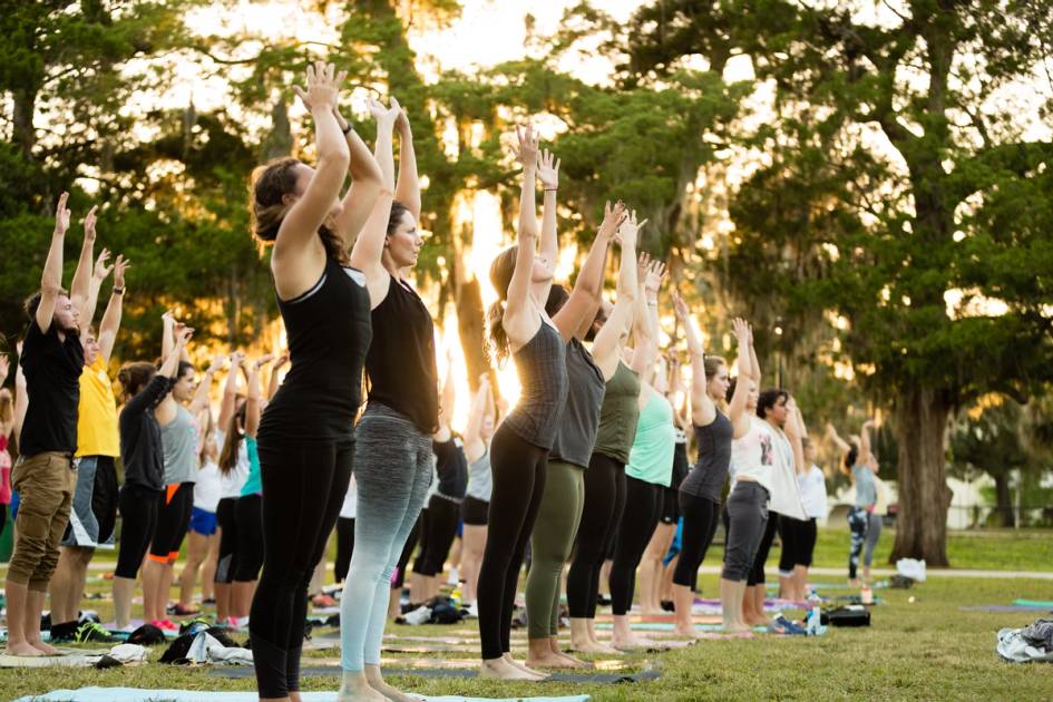 Students participating in an outdoor yoga class on campus.