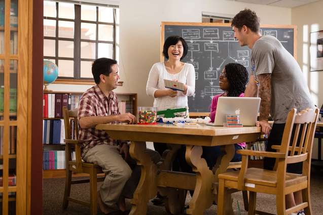 An education professor meeting with her students in the Hume House.
