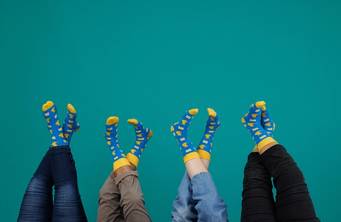 A group of people with Rollins College fox socks.