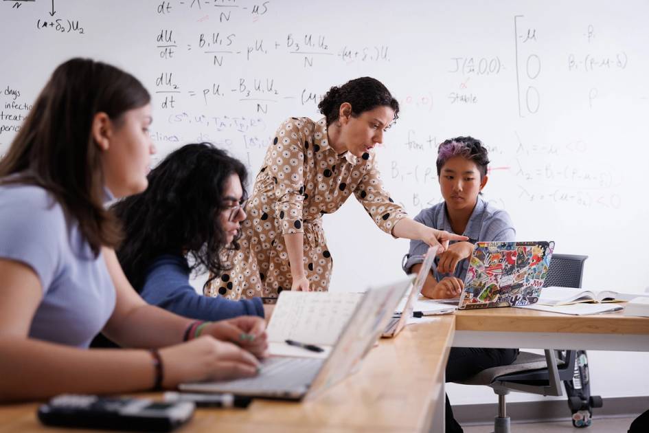 A math professor works one on one with a student during class.