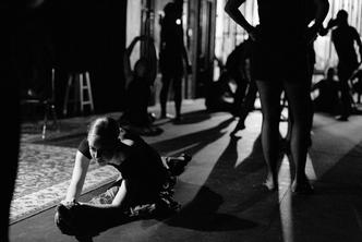 A student dancer stretches before class.