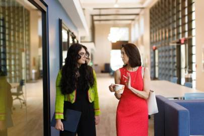 A student and professor walking together in Kathleen W. Rollins Hall