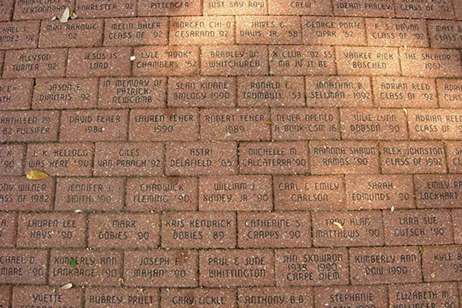 Bricks with various alumni names, grad years, and messages.