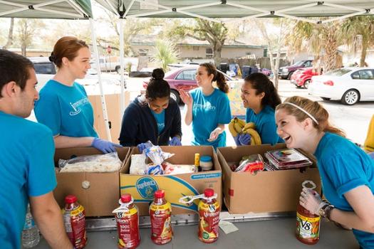 Rollins students packing food to donate for MLK Day of Service.